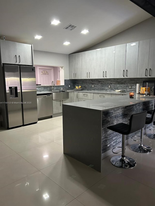 15281 SW 153rd St, Miami, FL 33187 - kitchen with tasteful backsplash, appliances with stainless steel finishes, light tile patterned flooring, a peninsula, and a kitchen breakfast bar