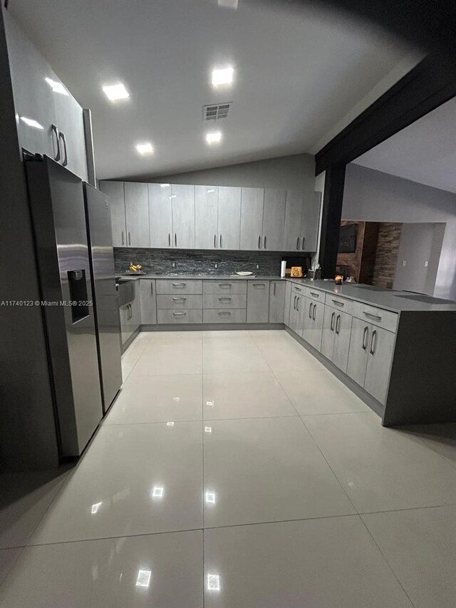 15281 SW 153rd St, Miami, FL 33187 - kitchen with stainless steel refrigerator with ice dispenser, light tile patterned floors, dark countertops, visible vents, and backsplash