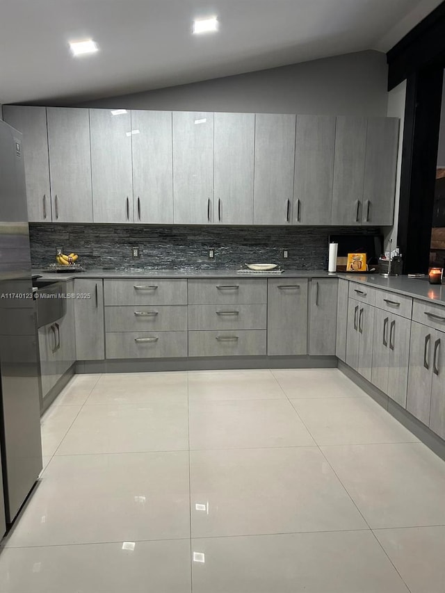 15281 SW 153rd St, Miami, FL 33187 - kitchen with light tile patterned floors, dark countertops, gray cabinets, and decorative backsplash