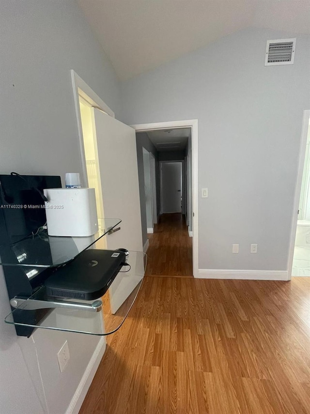 kitchen with vaulted ceiling and hardwood / wood-style floors