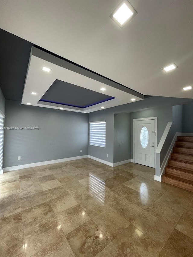 entryway with a tray ceiling