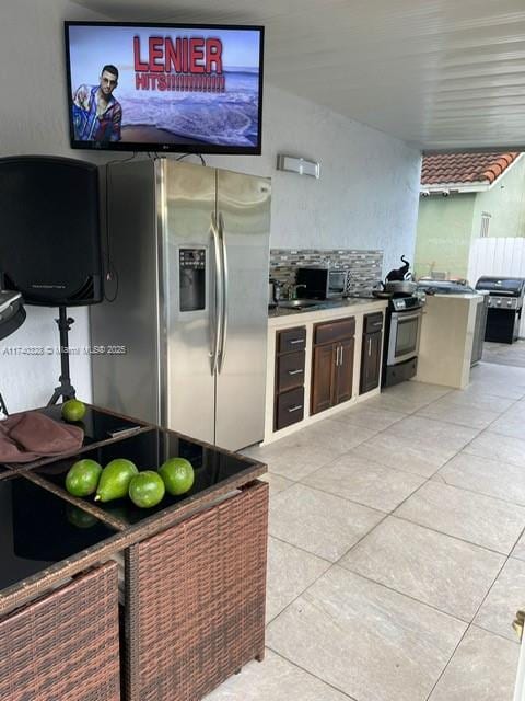 12676 NW 7th Ln, Miami, FL 33182 - kitchen with stainless steel refrigerator with ice dispenser and light tile patterned floors