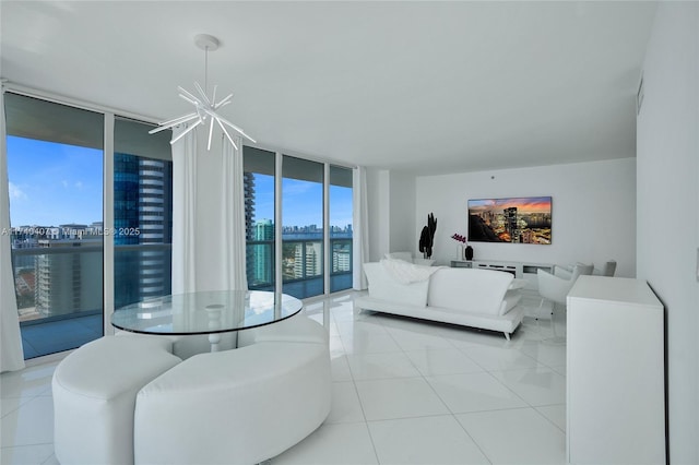 tiled living room featuring a wall of windows and a chandelier