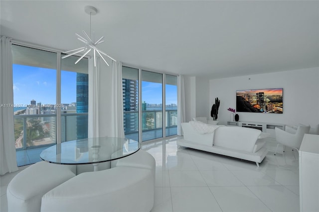 living room featuring light tile patterned flooring, a wall of windows, and a chandelier