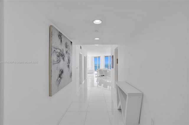 hall featuring light tile patterned floors