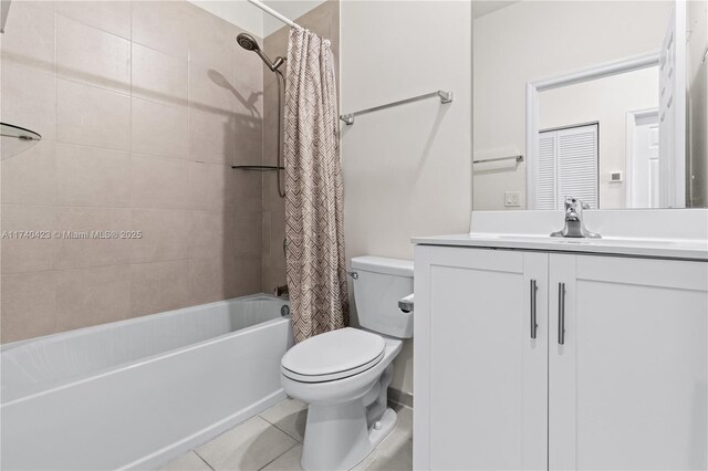 full bathroom with shower / tub combo with curtain, vanity, toilet, and tile patterned flooring