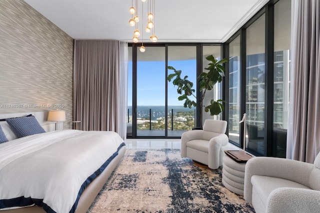 bedroom with floor to ceiling windows, access to exterior, and a chandelier