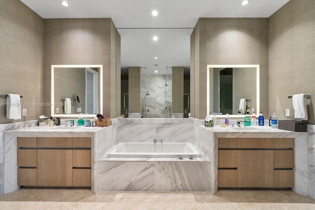 bathroom featuring shower with separate bathtub and vanity