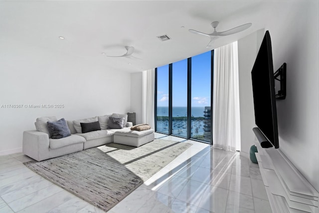 living room with expansive windows and ceiling fan