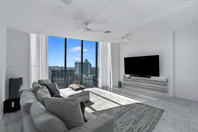 living room with expansive windows and ceiling fan