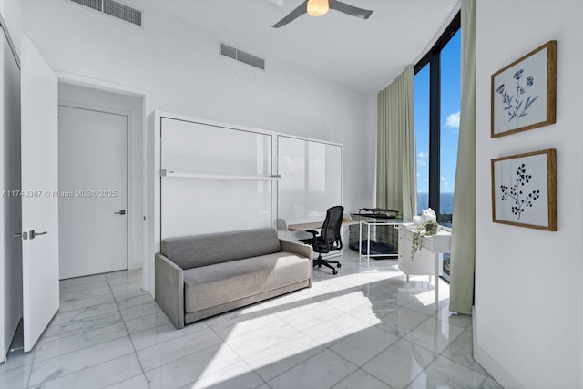 home office featuring floor to ceiling windows and ceiling fan