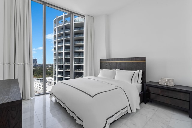 bedroom with access to exterior and floor to ceiling windows