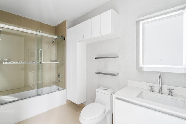 full bathroom with vanity, shower / bath combination with glass door, and toilet