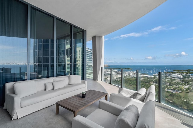 balcony featuring a water view and outdoor lounge area