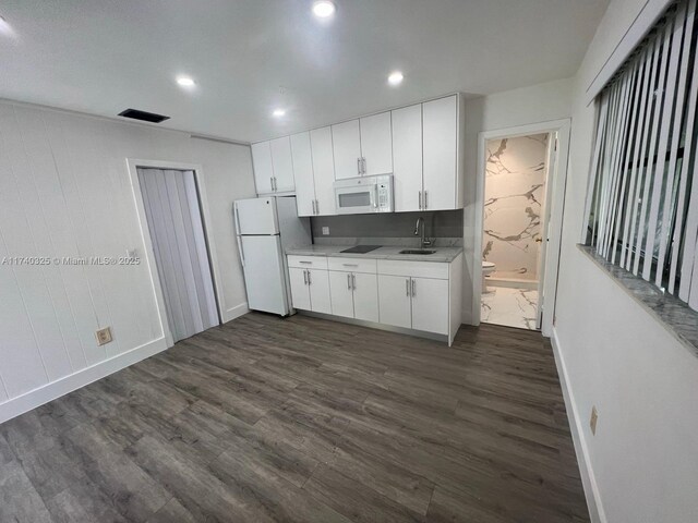 222 SW 8th St, Dania Beach, FL 33004 - kitchen featuring sink, white appliances, dark wood-type flooring, and white cabinets