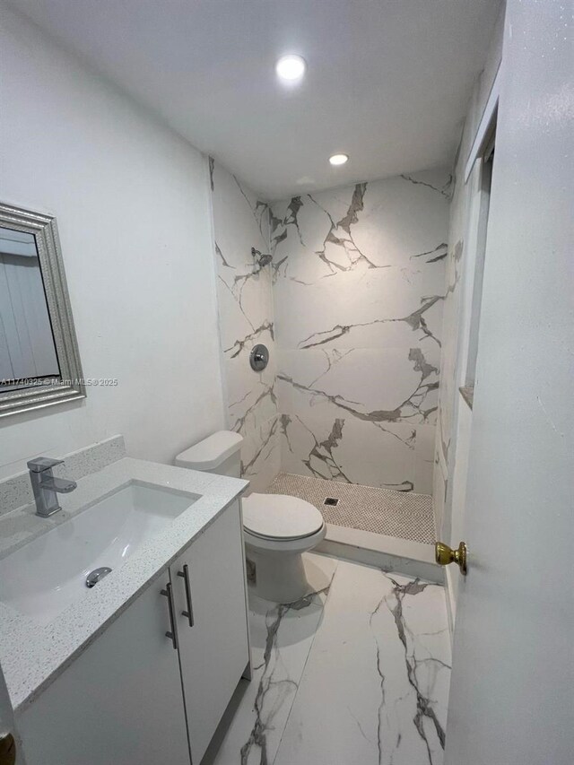 222 SW 8th St, Dania Beach, FL 33004 - bathroom with vanity, a tile shower, and toilet