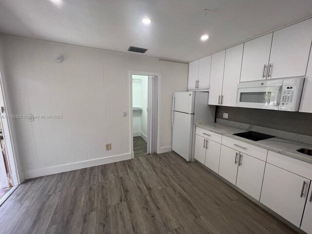 222 SW 8th St, Dania Beach, FL 33004 - kitchen with white appliances, dark wood-type flooring, light stone countertops, and white cabinets