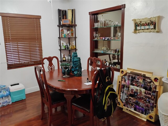 dining space with dark wood-type flooring