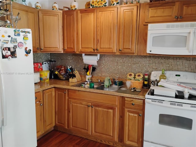 kitchen with white appliances, dark hardwood / wood-style flooring, sink, and decorative backsplash