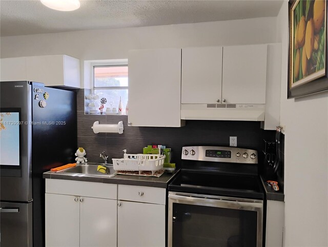 kitchen featuring sink, backsplash, white cabinets, and appliances with stainless steel finishes