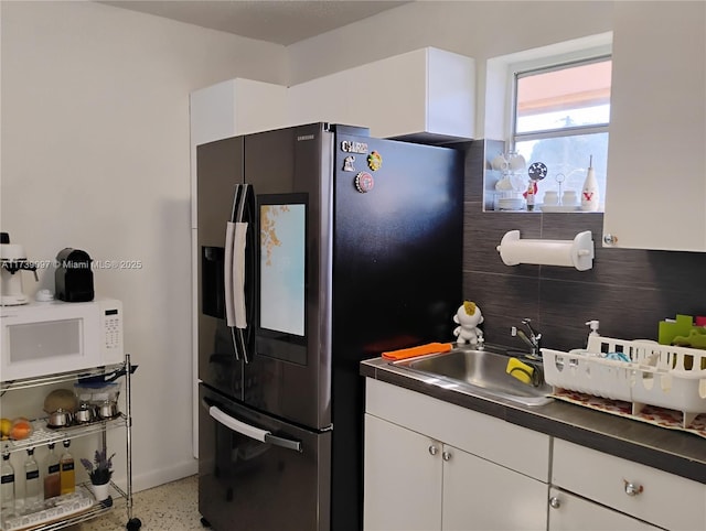 kitchen with sink, white cabinets, and stainless steel refrigerator with ice dispenser