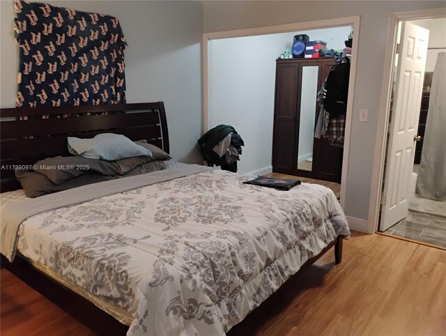 bedroom with hardwood / wood-style floors and a closet