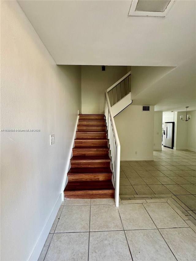 stairway featuring tile patterned floors