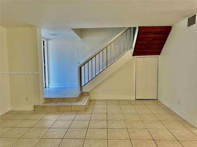 staircase with tile patterned floors