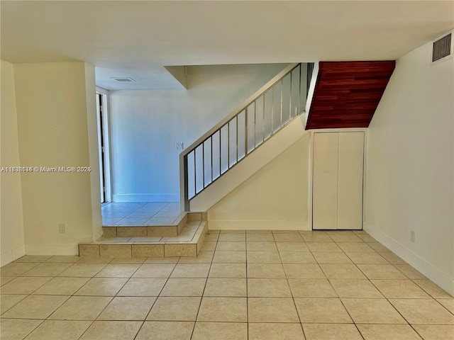 staircase with tile patterned floors