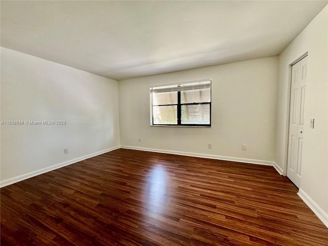 unfurnished room featuring dark hardwood / wood-style flooring