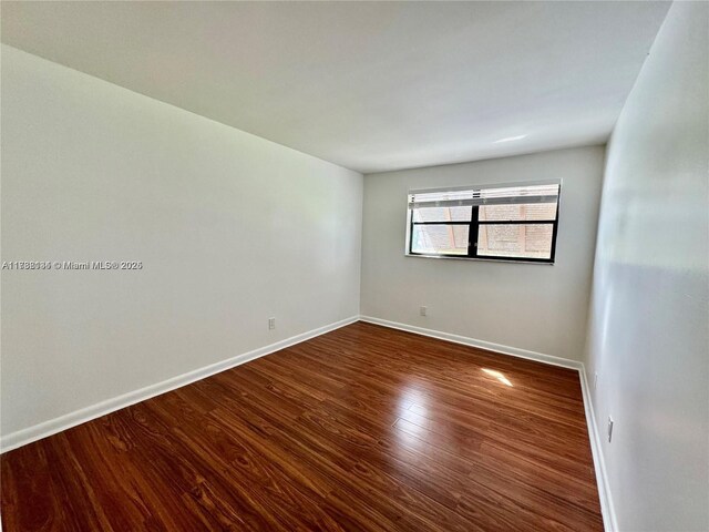 empty room featuring dark hardwood / wood-style floors