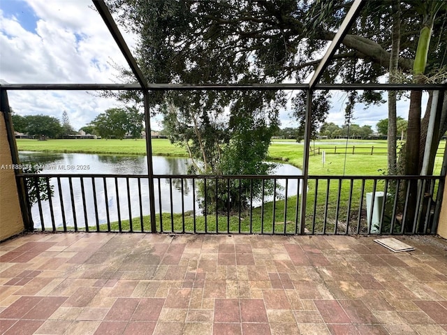 unfurnished sunroom featuring plenty of natural light and a water view