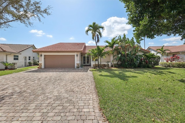 view of front of property with a garage and a front lawn