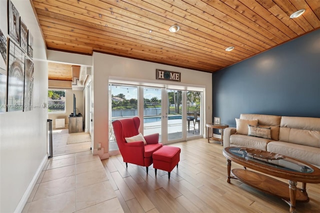 living room with wood ceiling, a healthy amount of sunlight, vaulted ceiling, and french doors