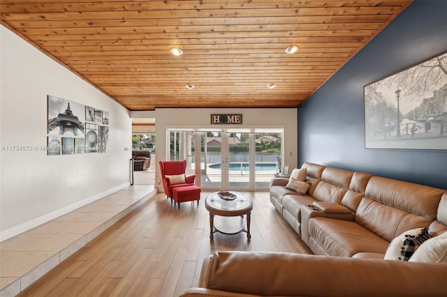 living room featuring lofted ceiling, wooden ceiling, light wood-type flooring, and french doors