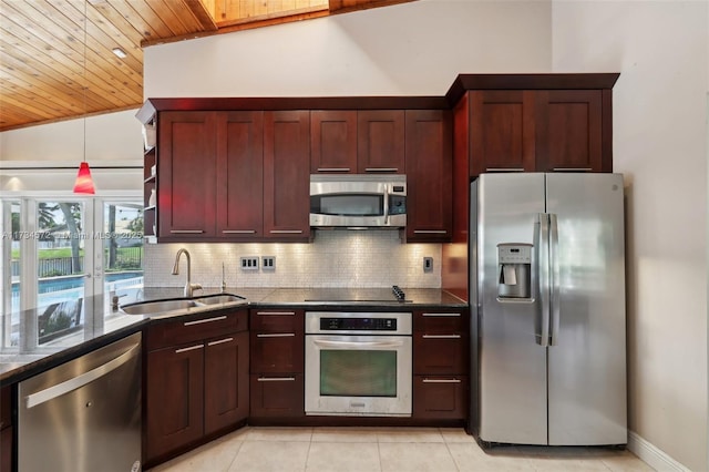 kitchen with sink, wood ceiling, vaulted ceiling, appliances with stainless steel finishes, and decorative backsplash