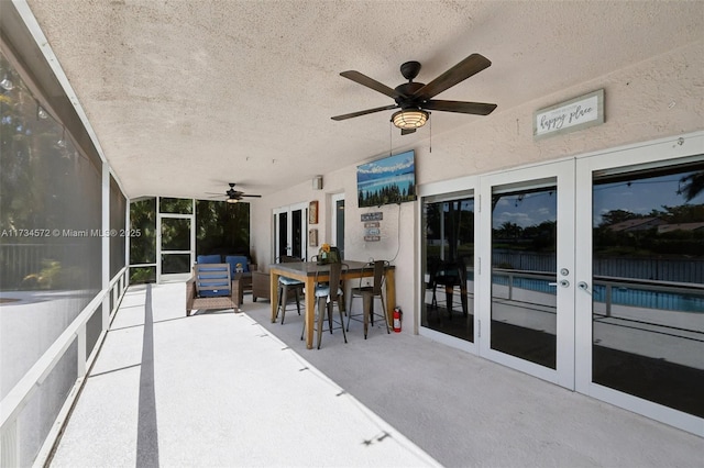 view of patio featuring french doors and ceiling fan