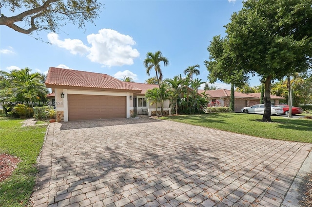 view of front of home featuring a garage and a front lawn