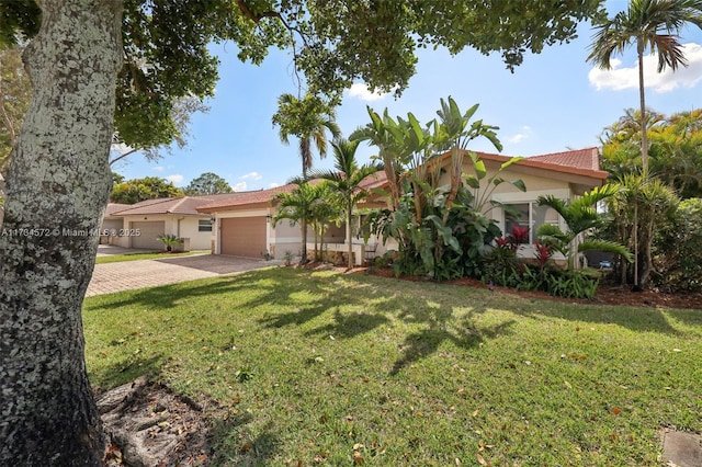 view of front facade with a garage and a front yard