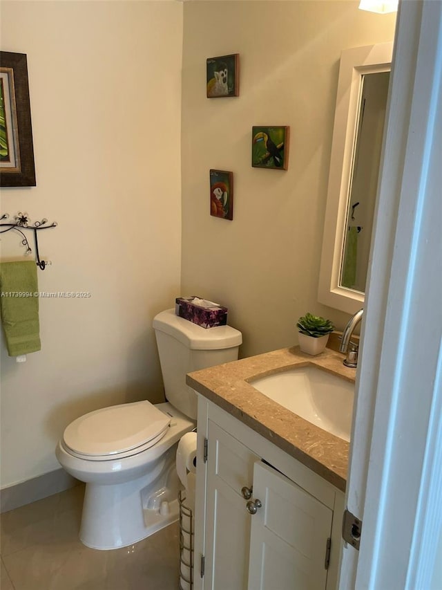 bathroom featuring vanity, toilet, and tile patterned flooring