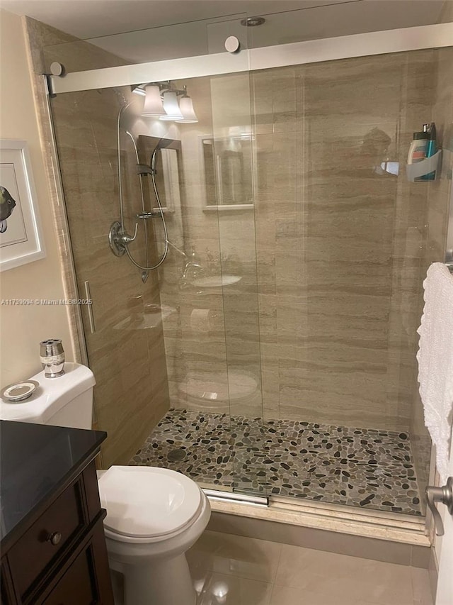 bathroom featuring vanity, toilet, and walk in shower