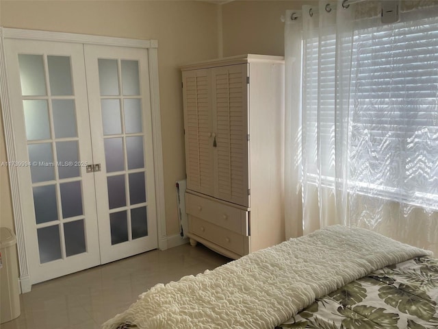 bedroom with light tile patterned flooring and french doors