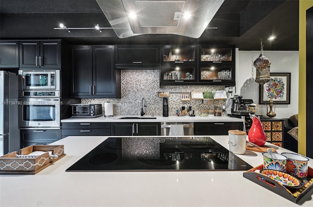 kitchen featuring tasteful backsplash, appliances with stainless steel finishes, and sink