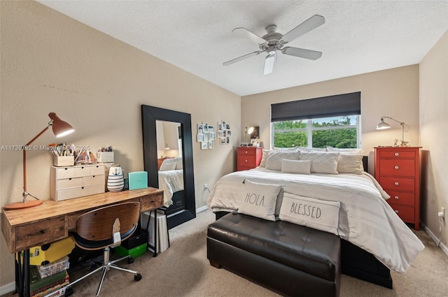 bedroom featuring carpet floors, a textured ceiling, and ceiling fan