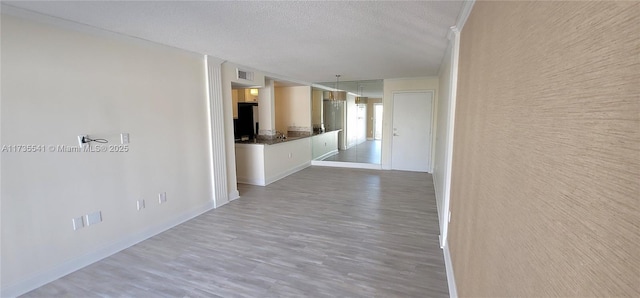 interior space with hardwood / wood-style flooring and a textured ceiling