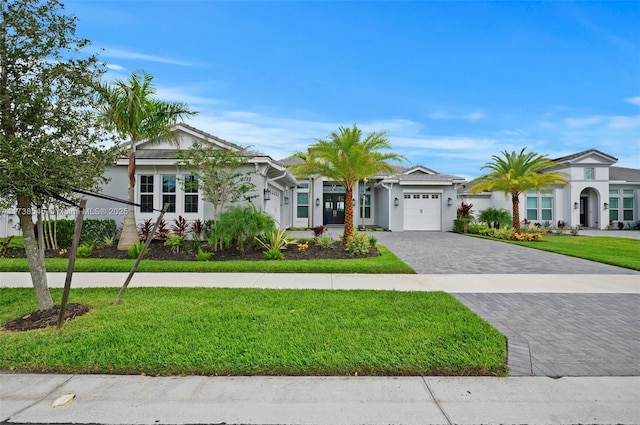 view of front of home featuring a garage and a front lawn