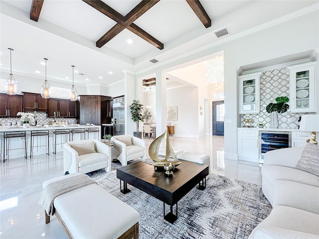 living room featuring wine cooler, coffered ceiling, crown molding, bar area, and beam ceiling