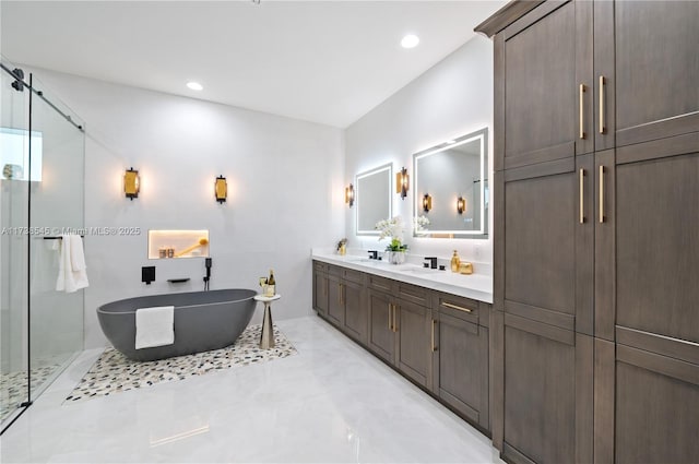 bathroom with vanity and shower with separate bathtub