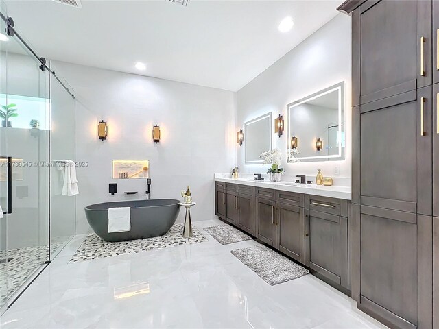 bathroom with vanity and shower with separate bathtub