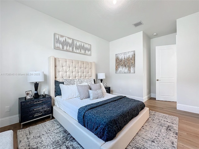 bedroom with hardwood / wood-style flooring